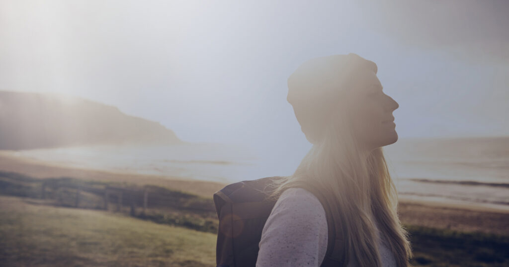 A serene individual standing by the ocean, symbolizing hope and the journey to overcoming anxiety.