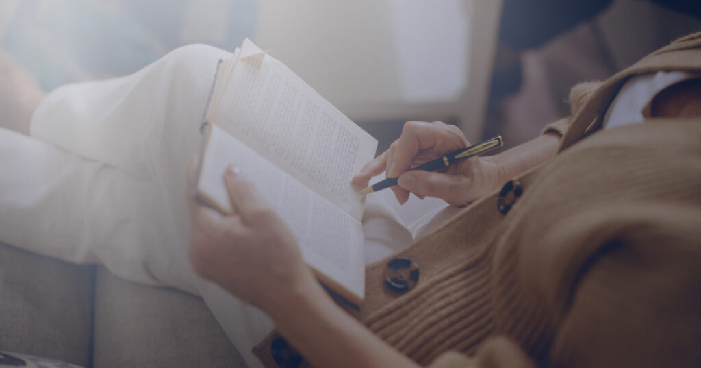 Close-up of a person writing in a journal, symbolizing self-reflection and active engagement in anxiety therapy.