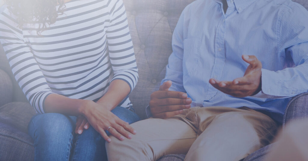 Couple in a therapy session, discussing relationship concerns with a counselor.